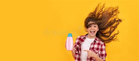 Happy Teen Girl With Long Curly Hair Hold Shampoo Bottle Beauty