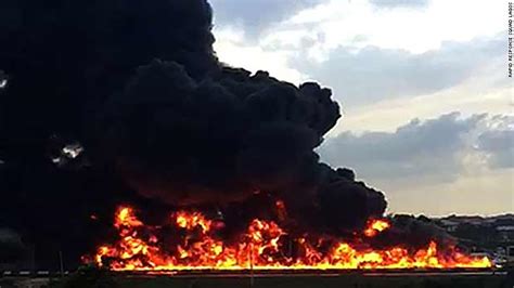 More like an ocean 'on' fire. Oil Tanker Explodes in Lagos, Nigeria, 54 Cars Burn in the ...