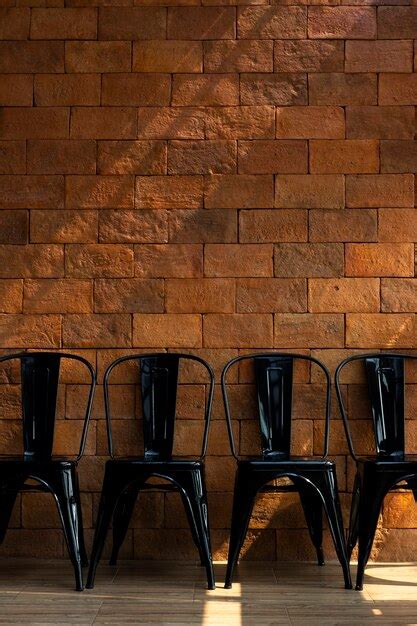 Premium Photo Red Brick Walls And Black Chairs