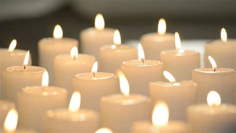 Edited Dolly Shot Of Multiple White Candles Burning With Soft Candle