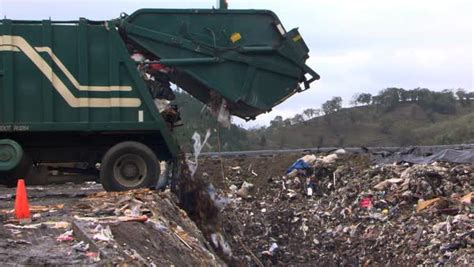 Garbage Truck Unloading Into Landfill Stock Video Footage Dissolve