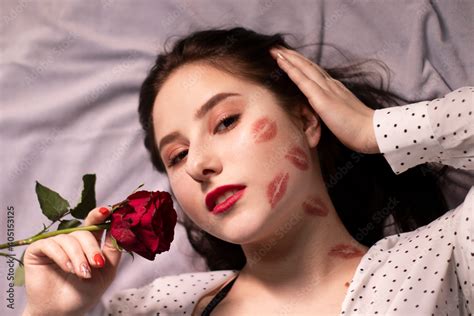 Sexy Brunette Woman With Kisses Lipstick Marks On Her Face And Neck With Red Rose Girlfriend