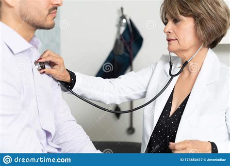 Doctor Examining Male Patient In Clinic Stock Image Image Of Care