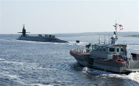 A U S Coast Guard Patrol Boat Right Escorts The Ballistic Missile