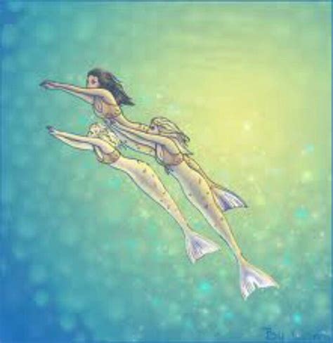 Two Mermaids Floating In The Water With Bubbles On Their Back And One