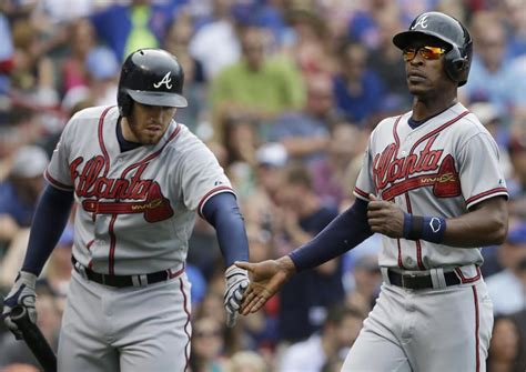 atlanta braves b j upton celebrates with freddie freeman after scoring on andrelton simmosons