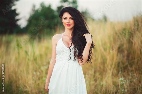 Busty Beautiful Young Girl In A Field In White Dress Has Beauti Stock