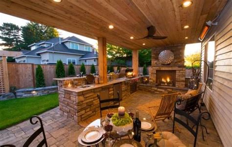 An Outdoor Kitchen And Dining Area Is Lit Up