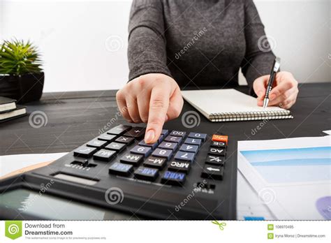 Close Up Of Female Accountant Or Banker Making Calculations Stock