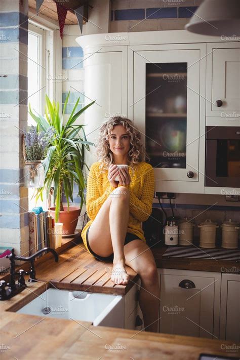 Beautiful Woman Having Coffee In Kitchen By Wavebreak On