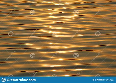 Mesmerizing Shot Of The Golden Sun Rays Reflecting In The Lake Stock