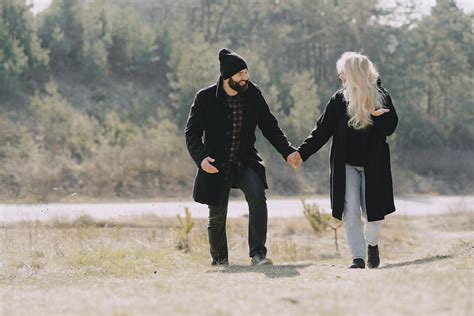 Romantic Lovers Walking And Holding Hands In Nature · Free Stock Photo
