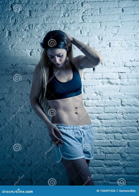 Portrait Of Sporty Beautiful Woman In Sport Clothes Looking Sensual And