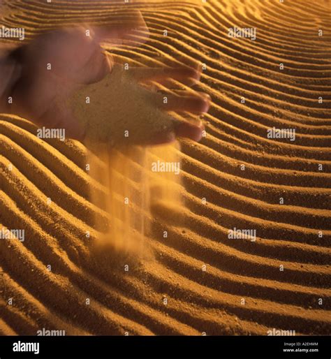 Hand Pouring Sand Stock Photo Alamy