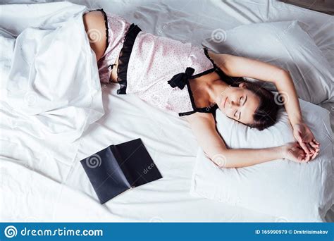 Girl In Pajamas Lying On The Bed With A Book Before Bed Stock Image