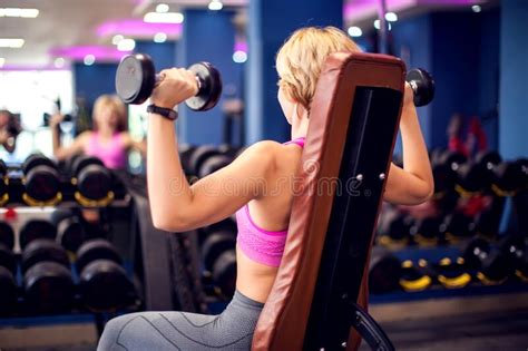 Woman Training Shoulders With Dumbbells In The Gym People Fitness And