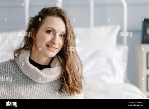 Close Up Portrait Of A Pretty Smiling Young Woman In Cozy Sweater Have