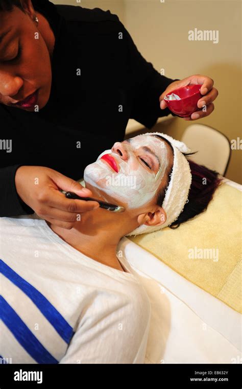 Beauty Salon White Woman Getting A Facial Treatment From A Black
