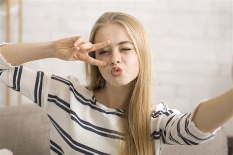 Cheerful Girl Taking Selfie Showing Duck Face And Peace Gesture Stock