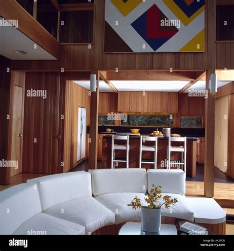 Curved white sofa in modern openplan living and dining room Stock Photo