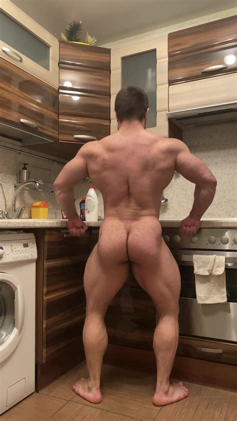 flexing bodybuilder posing in kitchen