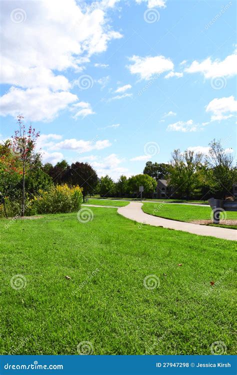 Neighborhood Sidewalk Winding Through A Park On A Beautiful Fall Day