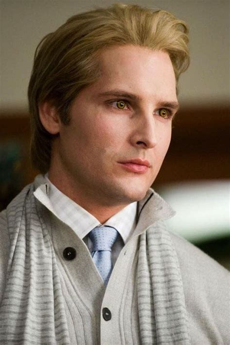 A Man With Blonde Hair Wearing A Sweater And Tie