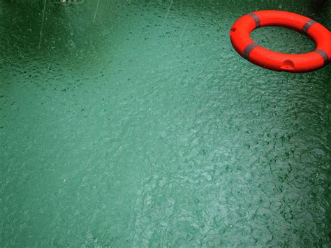 Rain Falling On Pool With Lifebuoy Photograph By Virginia Star