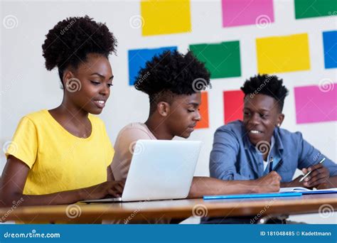 Learning African American Female Student At Computer With Group Of