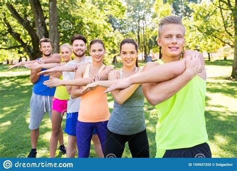 Group Of Happy People Exercising At Summer Park Stock Photo Image Of