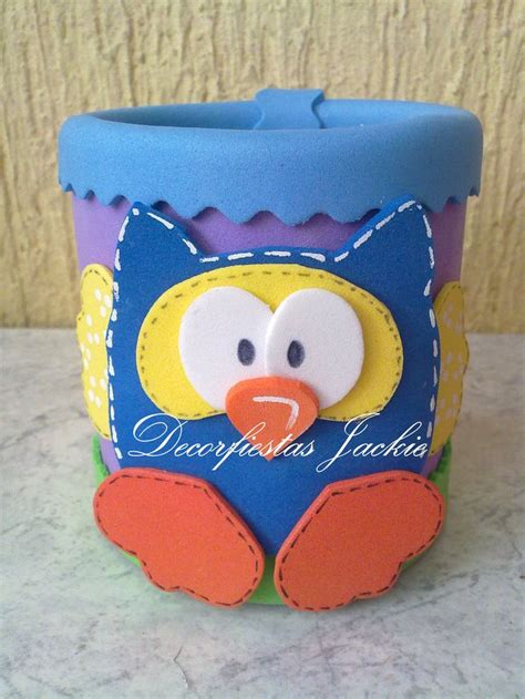 A Blue And Yellow Cup With A Bird On Its Face Sitting On A Counter