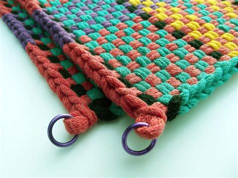 pair of large matching retro handmade woven hot pads potholders in bright colorful pattern hot