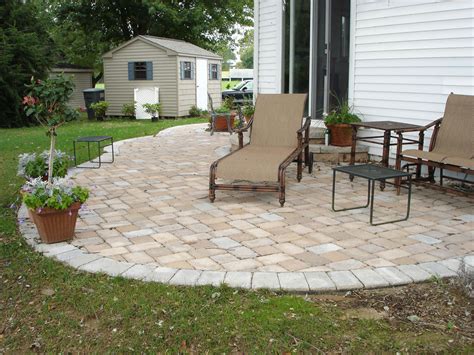 Cedar pergola with stone wrapped posts over dining area. Paver Patio Ideas for Enchanting Backyard - Amaza Design