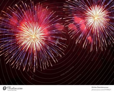 Fireworks Explode In Two Circles With Yellow Sparks From Red Smoke A