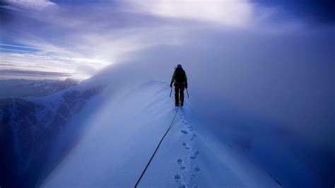 Person Walking On Snow Covered Mountain During Daytime Mont Blanc