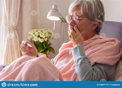 Suffering Elderly Adult Caucasian Woman With Cough And Fever As