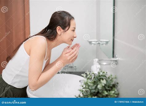 Beauty Asian Woman Washing Her Face With Clean Water Stock Photo