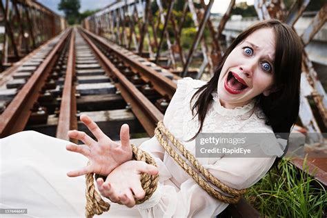 Pretty Girl In Victorian Dress Tied To Railroad High Drama High Res