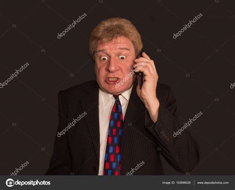 Shocking News Surprised Mature Man In Suit With Mobile Phone Stock