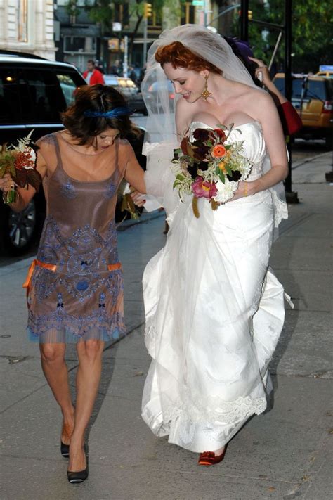 A Bride And Her Mother Walking Down The Street