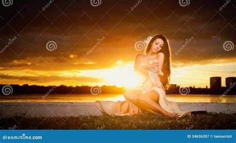 Brunette Caucasian Woman In Dress Posing Provocatively Outdoor In Front