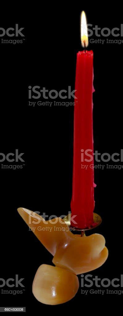 Candlestick Made Of Onyx With Red Burning Candle Isolated Stock Photo