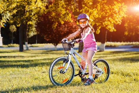 Child Riding A Bicycle The Kid In Helmet On Bike Stock Photo Image