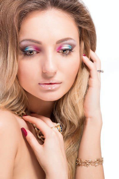 Beautiful Naked Blonde Girl With Bright Makeup And Long Curled Hair On