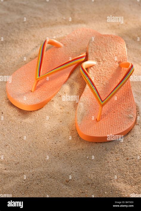 Pair Of Thongs On Sand Stock Photo Alamy