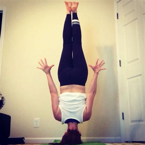 A Woman Is Doing A Handstand On The Floor