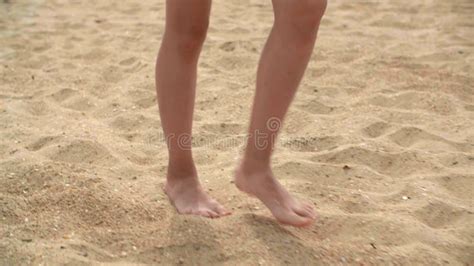 female barefoot feet walking on sand on summer beach close up barefoot girl legs walking on dry