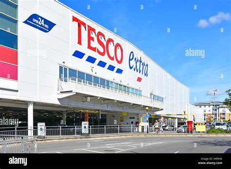 English Tesco Extra Store And 24 Hour Shopping Signs Above Ground Stock