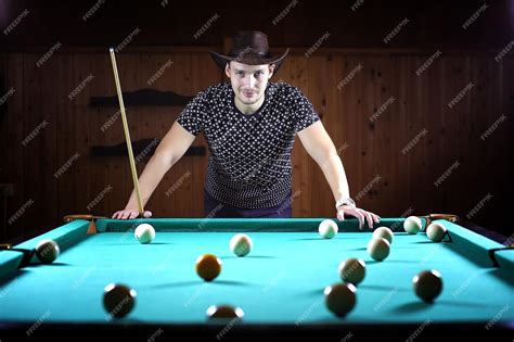 Premium Photo A Man With A Beard Plays A Big Billiard Party In 12 Foot Pool Billiards In The