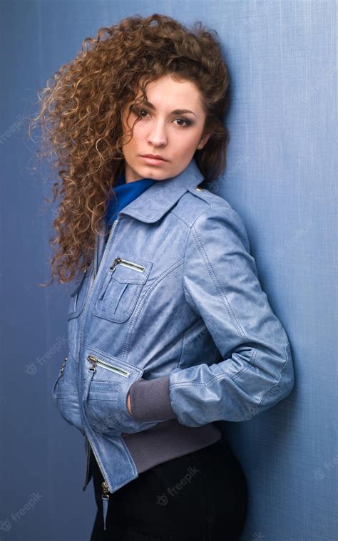 Premium Photo Pretty Girl With Curly Hair On A Blue Background